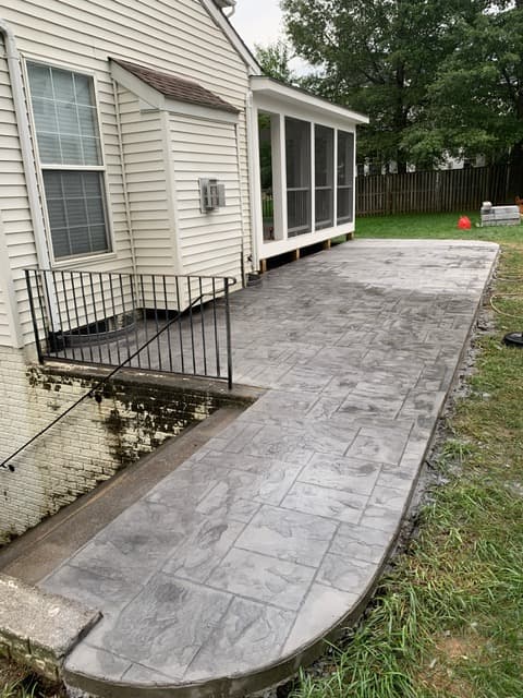 A new stamped-concrete patio built alongside the house